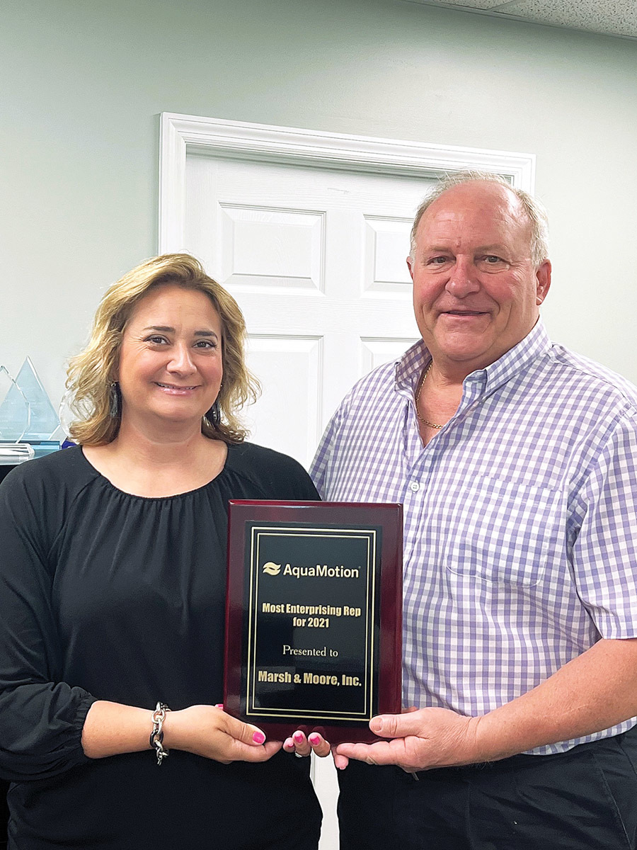 Marsh & Moore’s Jennifer Rodriguez, executive vice president, and Perry Hall, inside sales and quotations, receive their Most Enterprising Rep award plaque.