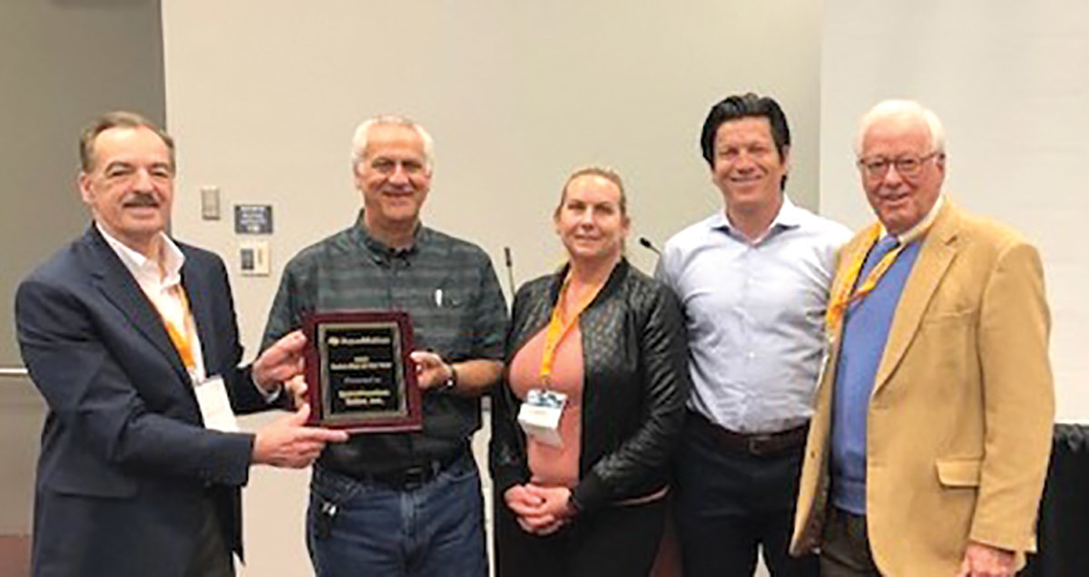 AquaMotion’s National Sales Manager Rich Gruber presents the 2021 Rep of the Year award plaque to Specification Sales representatives David Hutchins, Chrissy Hamm, and Chris Sweeny. Also pictured is AquaMotion President Hans Kuster.